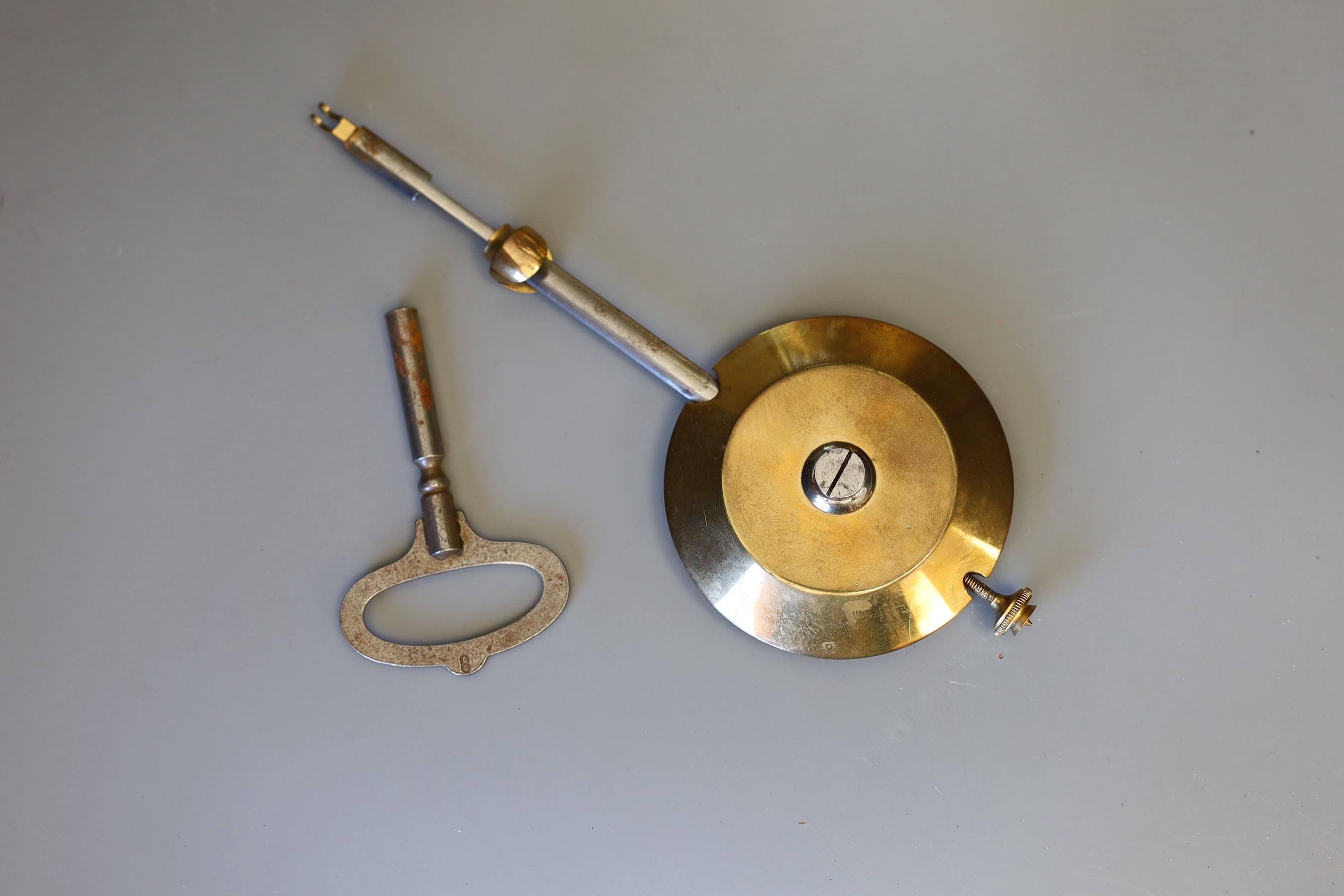 A 19th century French four glass mantel clock, with key and pendulum, 27cms high